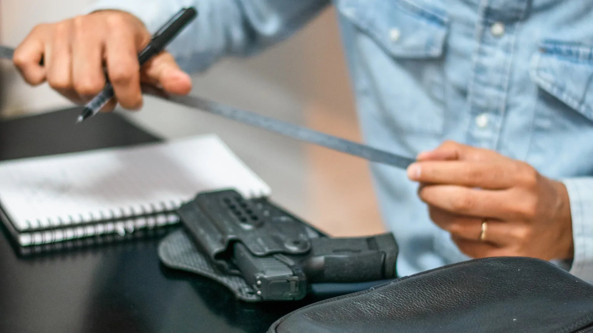 Zendira designer measuring bag dimensions for firearm fit to ensure safe and functional concealed carry design.