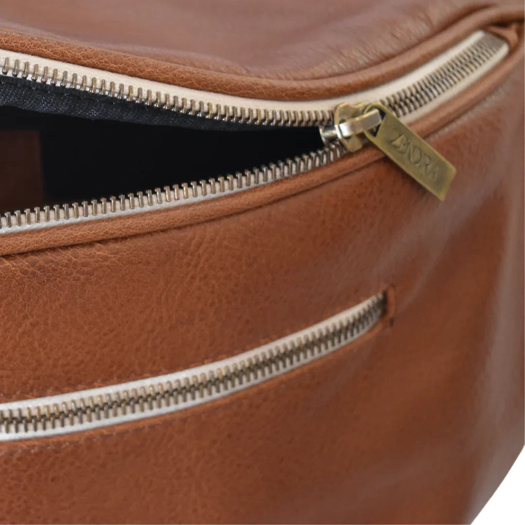 Detail view of the Zendira Saturday concealed carry crossbody bag in toffee with zipper