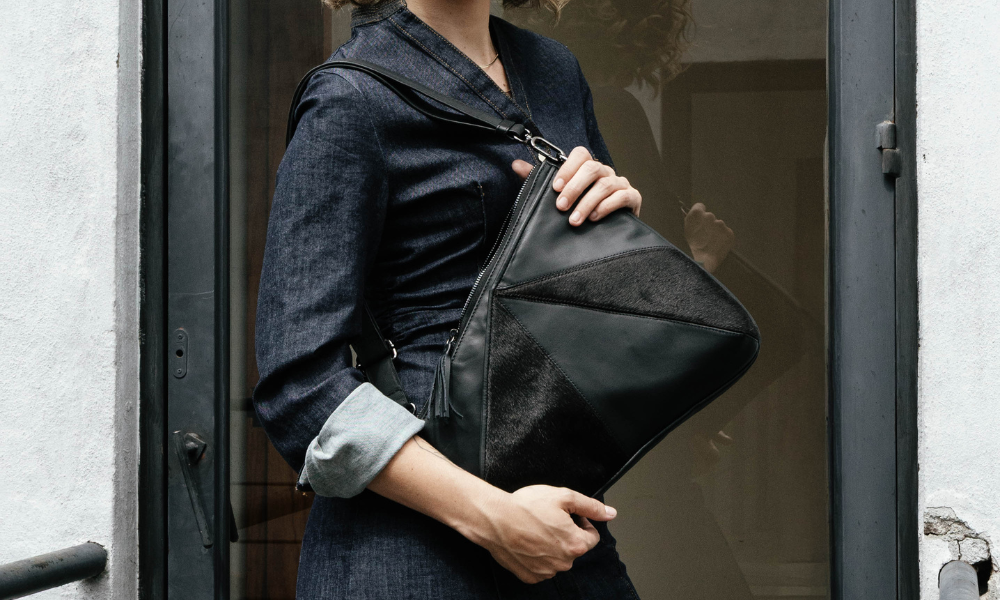 woman with a black nappa leather and black hair on hide Zendira Signature Collection Origami bag