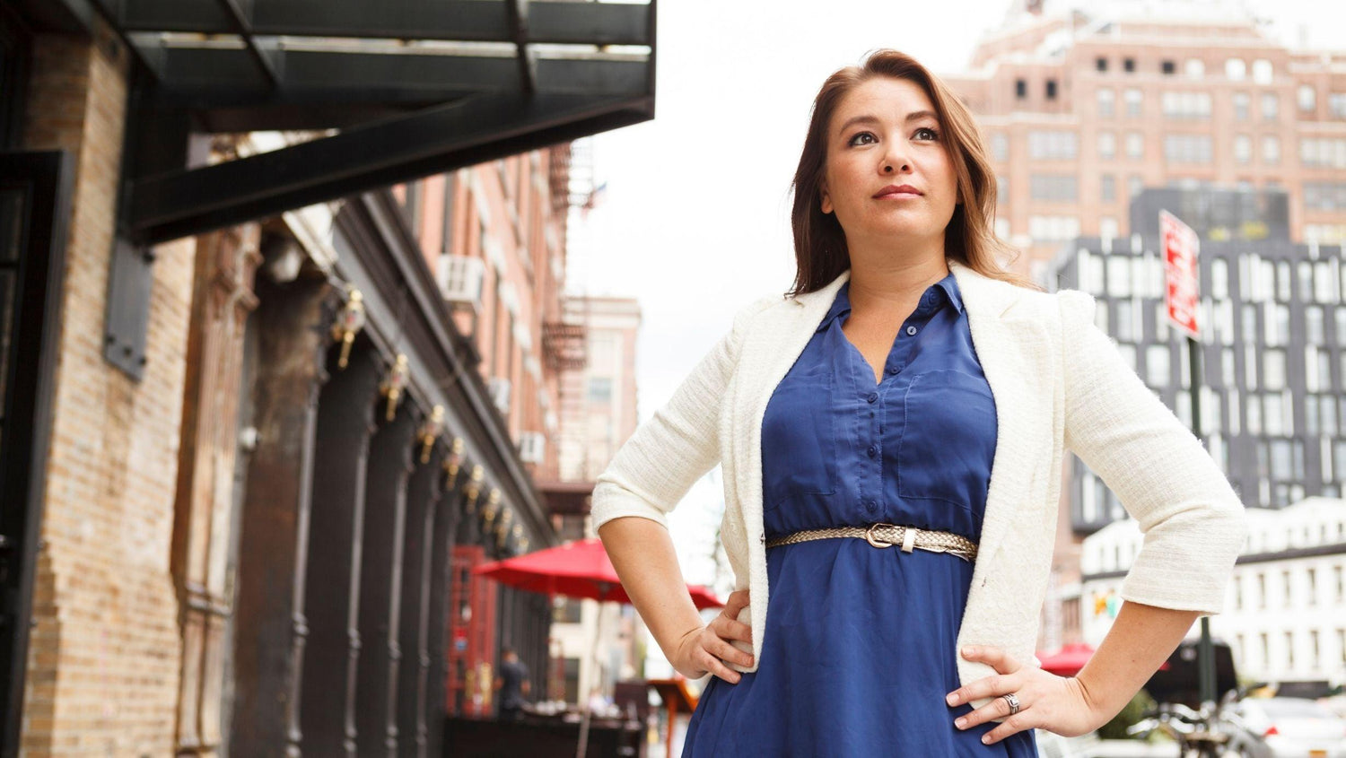 Confident woman wearing layers in a city.