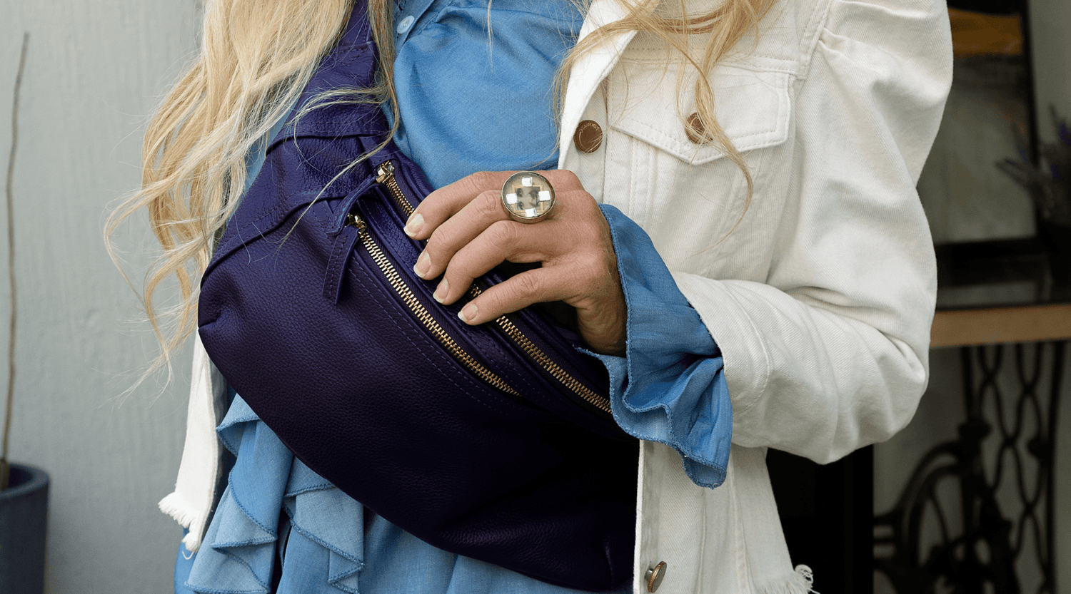 A woman with a Zendira Friday Concealed Carry Belt Bag after attending live-fire education at the A Girl and A Gun National Conference