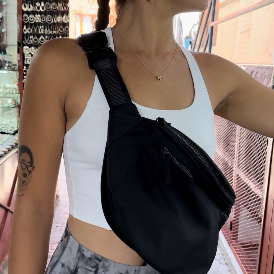 Young woman shopping a market while wearing a Zendira Active Friday bag while traveling on vacation.