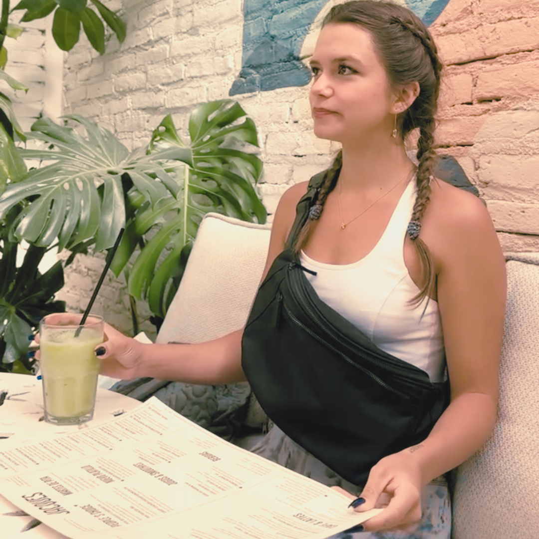 Young woman wearing a Zendira Active Friday bag while traveling on vacation.