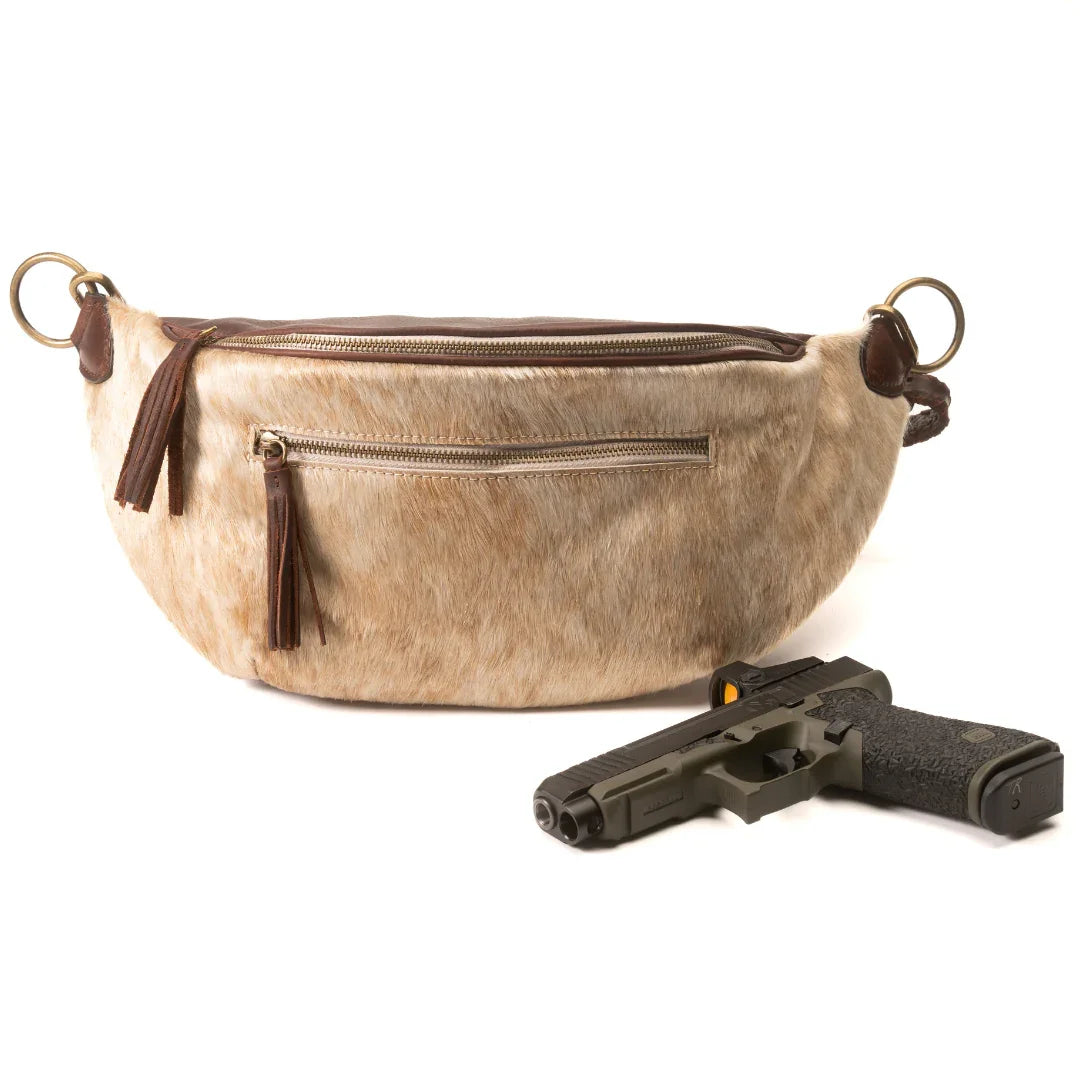 Jessie Harrison x Zendira concealed carry crossbody shown with compatible firearm