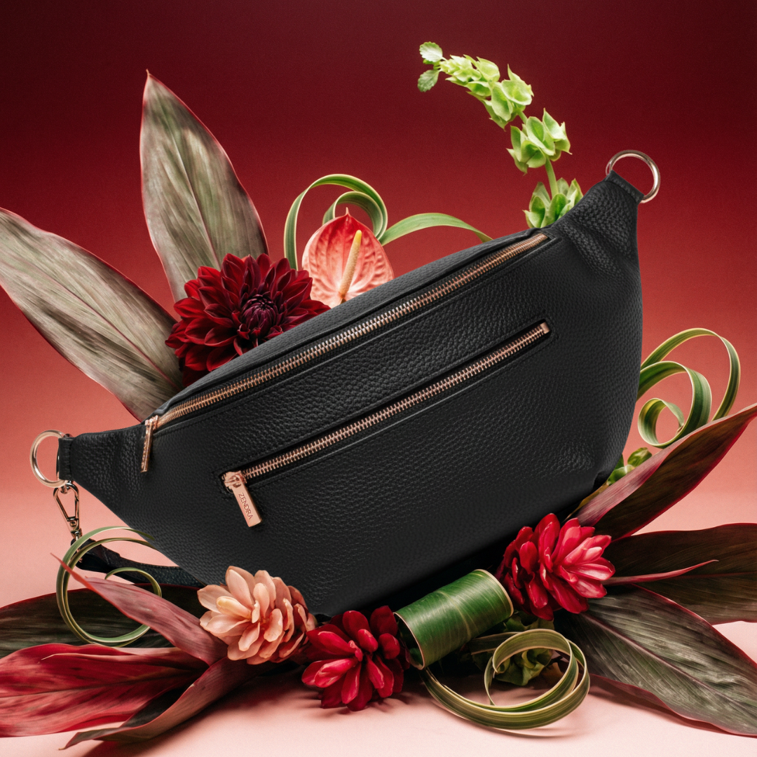 Zendira Saturday concealed carry bag in black rose on top of flowers
