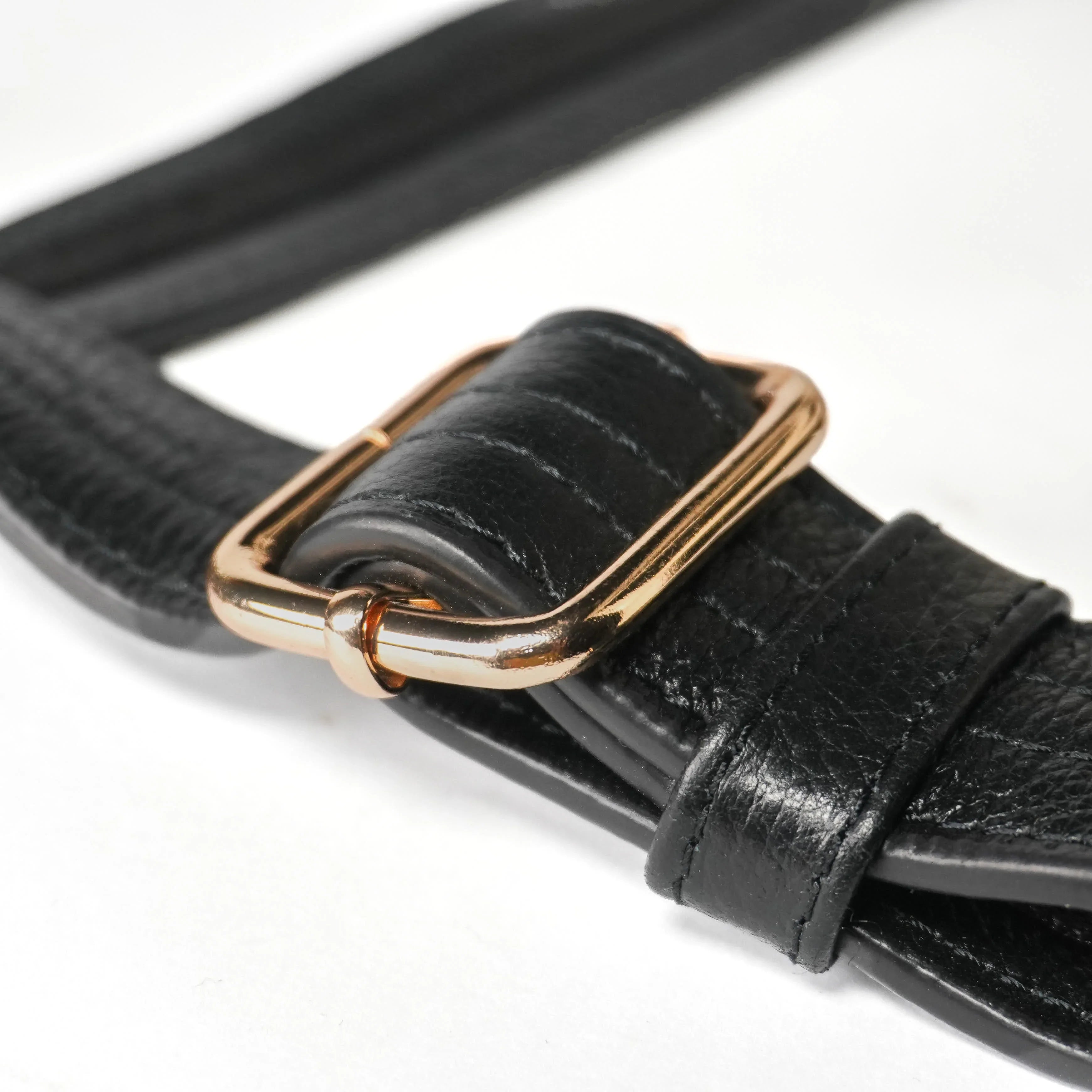 Close-up of cut-resistant strap and gold hardware on Zendira Sofia concealed carry bag