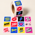 STRAPPED HELL YES roll of colorful square target paster stickers featuring lips, lightning bolts, hearts, and bold graphics for shooting targets.